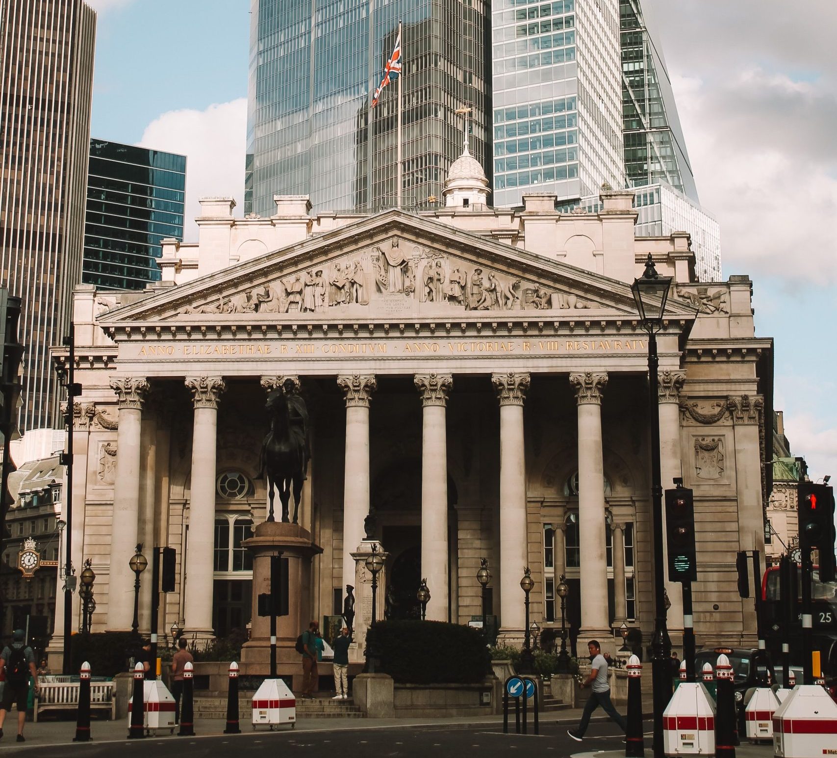 A striking picture of the Bank of England with a prominent skyscraper behind it.